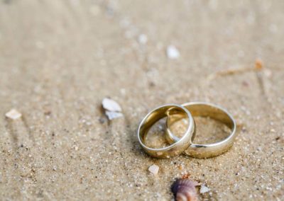 Beach Wedding Photography - wedding rings on beach sand